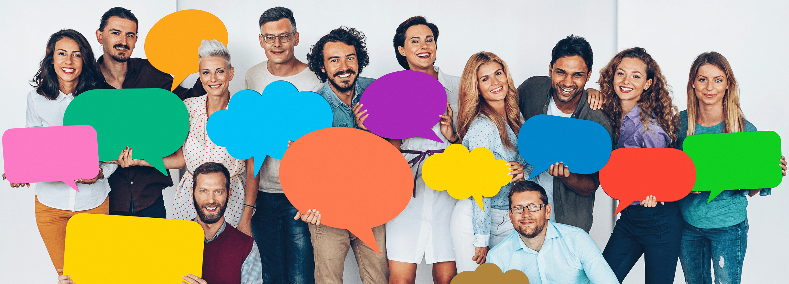 Photo of a group of adults holding speech bubbles to indicate 